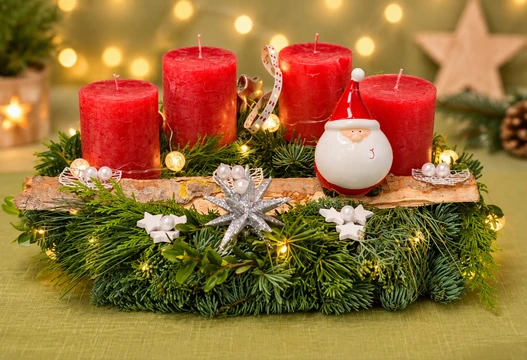 Adventskranz halbrund in Rot mit vier roten Kerzen, Tannengrün, Birkenrinde und Weihnachtsmann-Figur